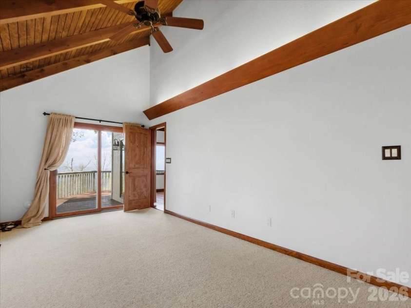 49 Slickrock Ridge Way, Burnsville, NC 28714.  MLS# CAR4367218, YatesRealty ID 25177. Sliding glass doors from primary bdrm to open deck