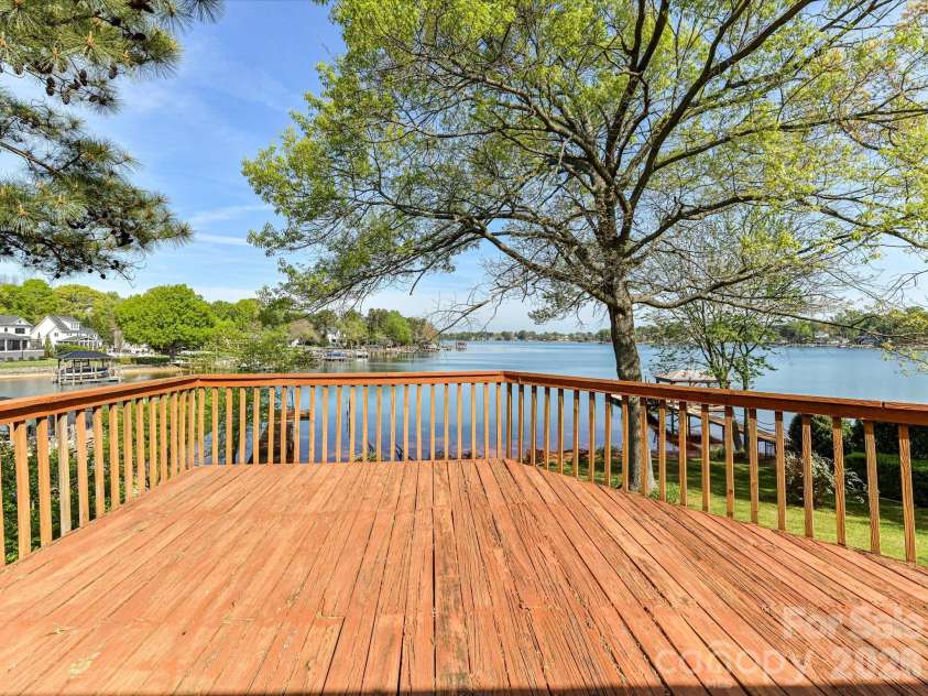 20337 Norman Colony Road, Cornelius, NC 28031.  MLS# CAR4374187, YatesRealty ID 25179. Expansive back deck overlooking Lake Norman, offering the perfect setting for relaxing, entertaining, and enjoying stunning water views.