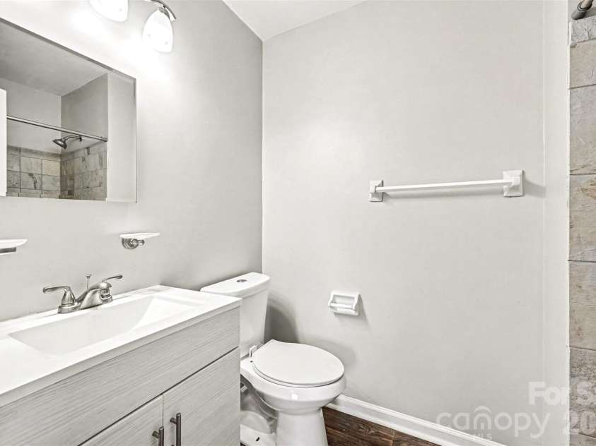 6165 Meadow Rose Lane, Charlotte, NC 28215.  MLS# CAR4406012, YatesRealty ID 25191. Primary bathroom - updated lighting, new vanity with solid surface sink and counter and more...