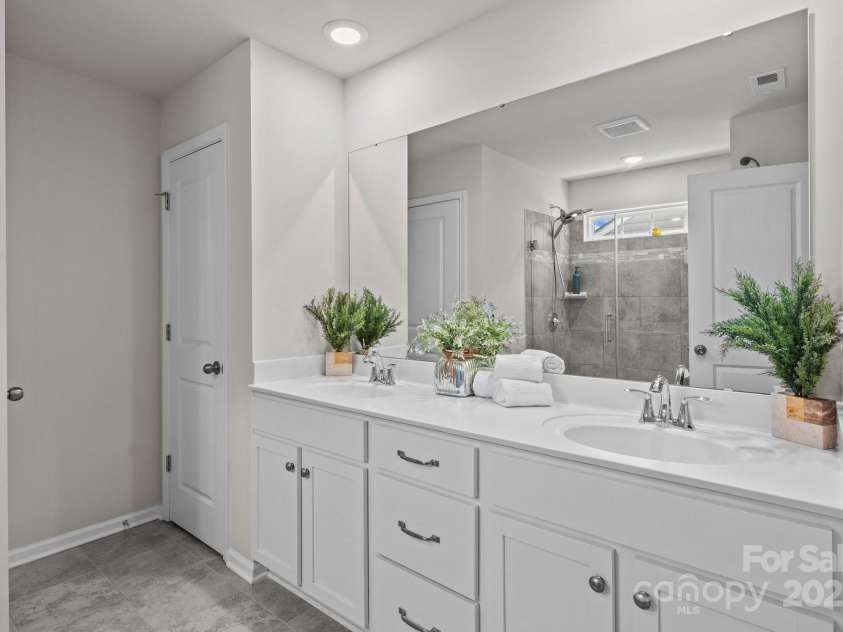 169 Rooster Tail Lane, Troutman, NC 28166.  MLS# CAR4272207, YatesRealty ID 25193. Primary bath with dual sinks and water closet