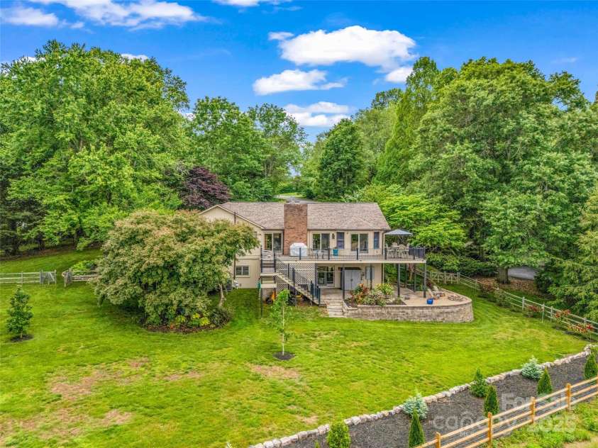 11 Bannerwood Drive, Horse Shoe, NC 28742.  MLS# CAR4257161, YatesRealty ID 25194. Fenced backyard with a mountain view overlooking a working vegetable farm