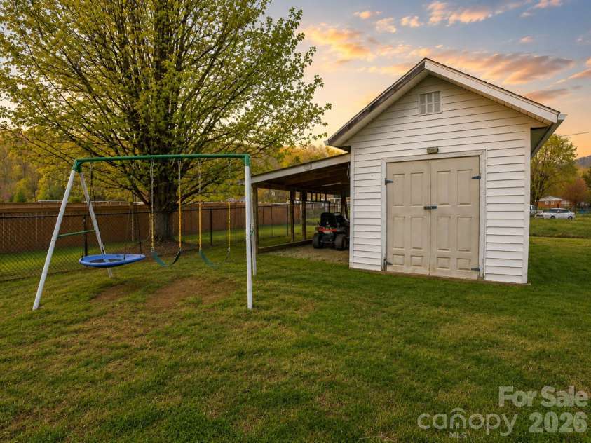 22 Brookfield Lane, Old Fort, NC 28762.  MLS# CAR4362830, YatesRealty ID 25205. Shed and leanto for additional backyard storage