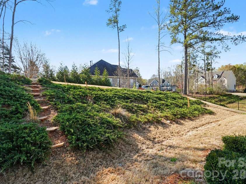 10885 Greenvale Drive, Harrisburg, NC 28075.  MLS# CAR4356120, YatesRealty ID 25209. Back yard showing upper and lower level