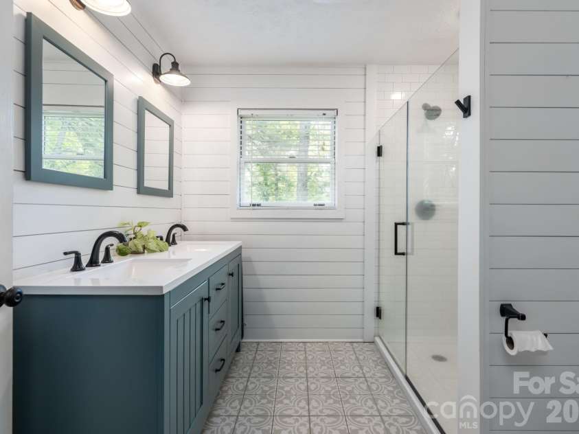 10 Terrapin Trail, Flat Rock, NC 28731.  MLS# CAR4381430, YatesRealty ID 25215. Updated bathroom with dual vanity and dual shower heads