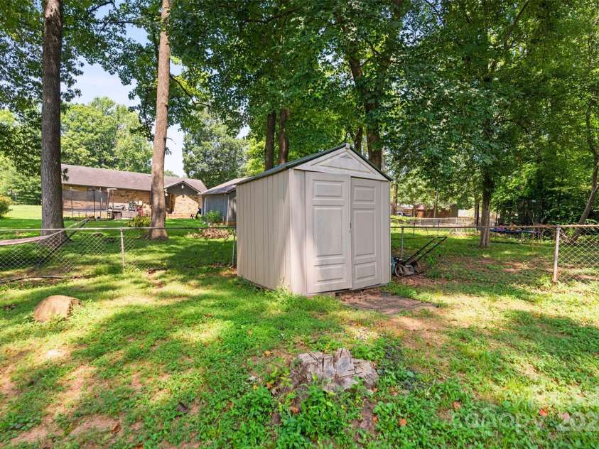 10108 Starwood Drive, Charlotte, NC 28215.  MLS# CAR4277537, YatesRealty ID 25221. Cute little shed at the back corner of the yard