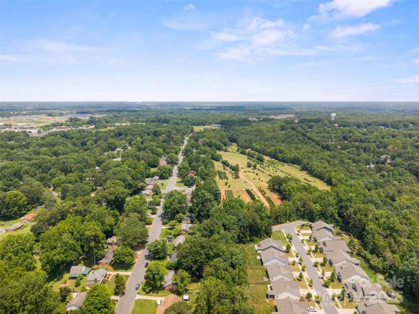 10108 Starwood Drive, Charlotte, NC 28215.  MLS# CAR4277537, YatesRealty ID 25221. This is drone footage showing the water tower in the top right of the picture that is Harrisburg.  To the left at the top of the picture is Farmington Ridge and behind Farmington Ridge is Hwy 49 that leads into the UN