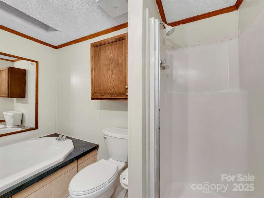 3215 Shadybark Trail, Catawba, SC 29704.  MLS# CAR4329918, YatesRealty ID 25226. Primary bathroom with garden tub and walk-in shower