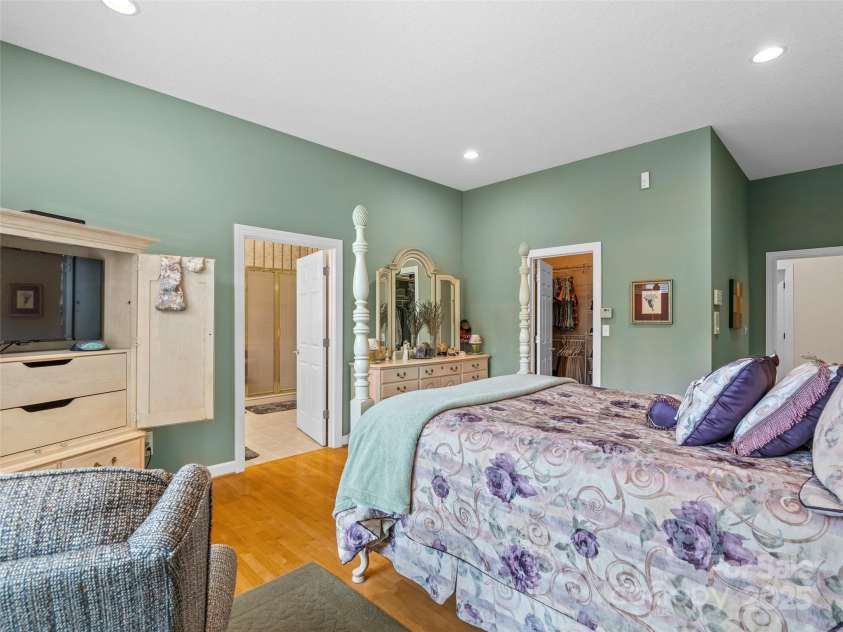 5 Reynolds Place, Asheville, NC 28804.  MLS# CAR4243705, YatesRealty ID 25235. Primary bedroom with separate access to the  screened porch