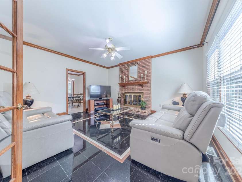 3100 Shady Grove Lane, Matthews, NC 28104.  MLS# CAR4278146, YatesRealty ID 25238. Family room with fireplace