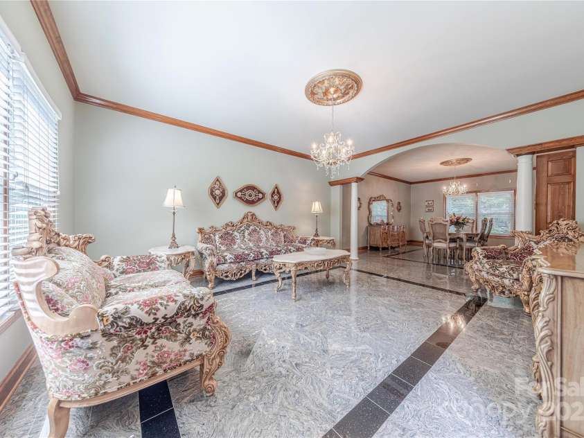 3100 Shady Grove Lane, Matthews, NC 28104.  MLS# CAR4278146, YatesRealty ID 25238. Living room with custom marble tile