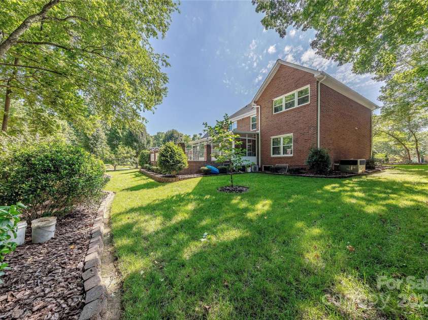 3100 Shady Grove Lane, Matthews, NC 28104.  MLS# CAR4278146, YatesRealty ID 25238. Lush landscaping surrounds the property