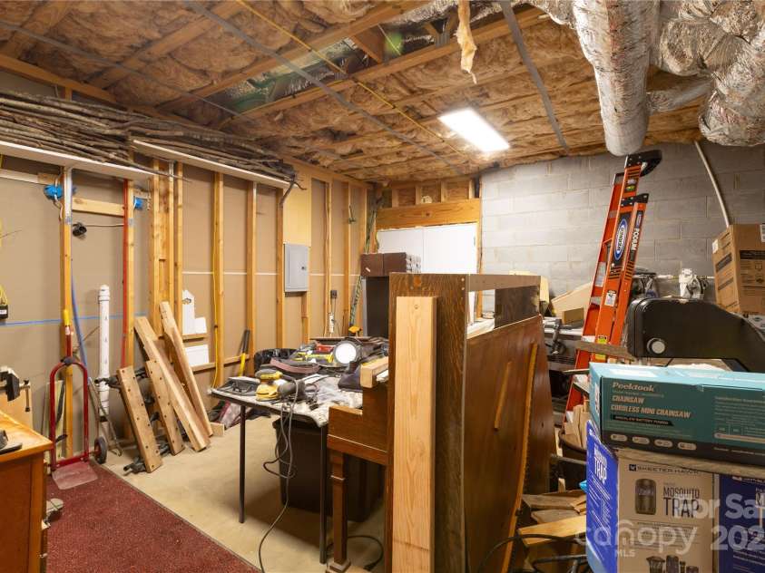 219 Sandalwood Drive, Whittier, NC 28789.  MLS# CAR4255681, YatesRealty ID 25244. Workshop in Basement area