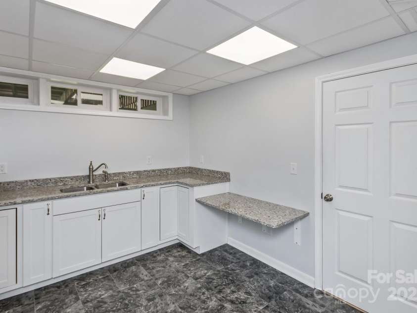 27 Glen Crest Drive, Arden, NC 28704.  MLS# CAR4249599, YatesRealty ID 25264. Lower level kitchen - full kitchen