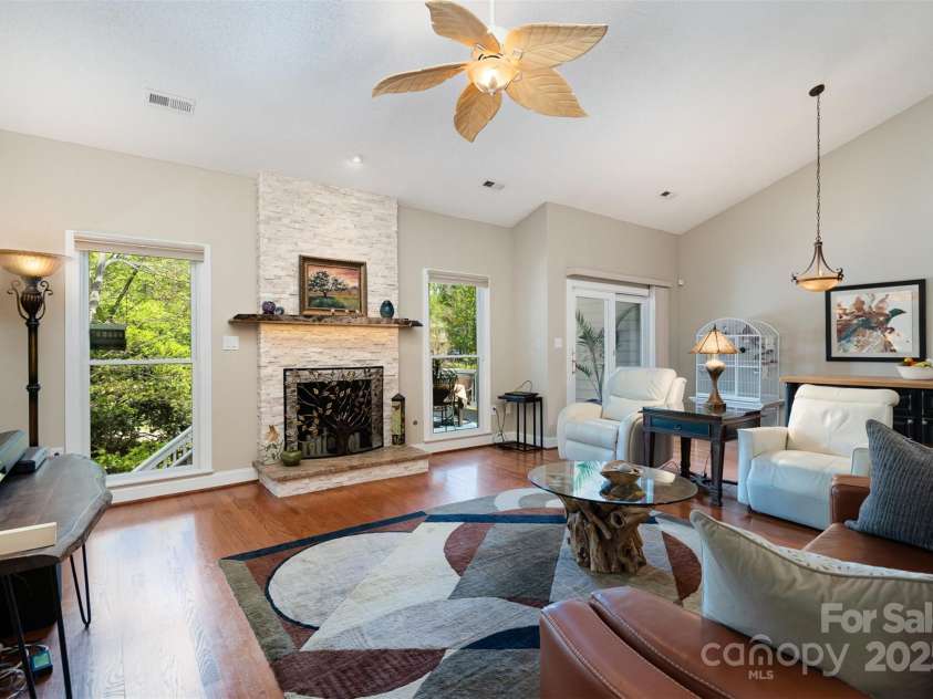 3813 Beauvista Drive, Charlotte, NC 28269.  MLS# CAR4275235, YatesRealty ID 25268. Open and airy family room, if you look closely you'll see the live edge fireplace mantle
