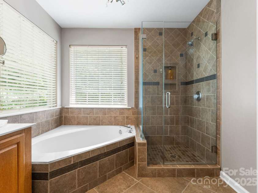 11202 Mountain Pine Drive, Charlotte, NC 28214.  MLS# CAR4273710, YatesRealty ID 25269. Garden Tub and Frameless Shower