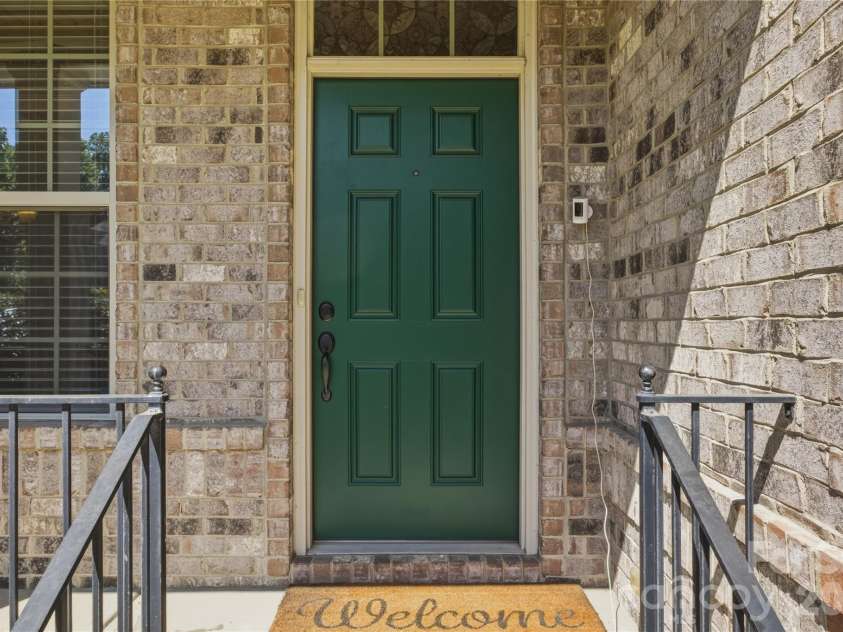 8306 Early Bird Way, Mint Hill, NC 28227.  MLS# CAR4375925, YatesRealty ID 25288. Inviting front entry with a bold statement door, classic brick exterior, and charming covered porch. A warm and welcoming first impression that sets the tone for the rest of the home.