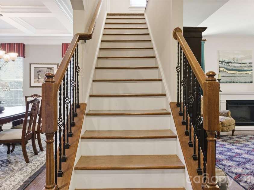 8306 Early Bird Way, Mint Hill, NC 28227.  MLS# CAR4375925, YatesRealty ID 25288. Striking staircase centerpiece featuring hardwood treads, wrought iron balusters, and timeless craftsmanship. This elegant architectural feature creates a grand first impression and enhances the home's open, airy feel.