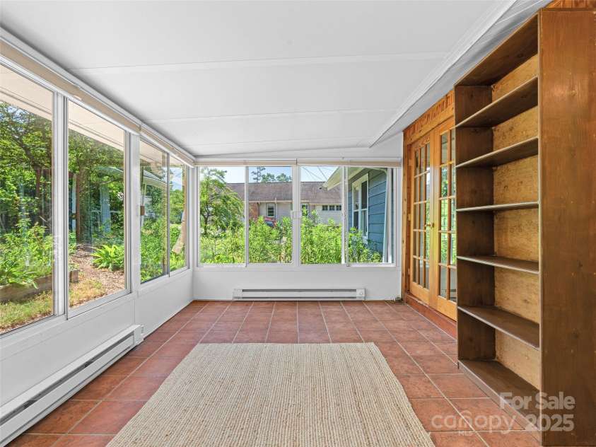 83 5th Avenue, Asheville, NC 28806.  MLS# CAR4275954, YatesRealty ID 25294. 4 seasons room gives lovely views of the gardens all year long.