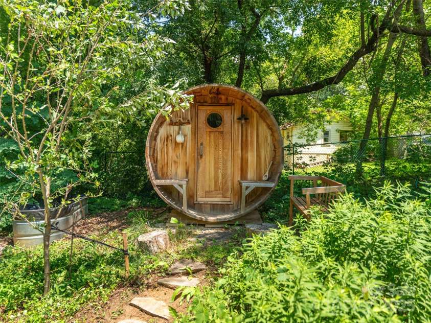 83 5th Avenue, Asheville, NC 28806.  MLS# CAR4275954, YatesRealty ID 25294. Barrel sauna flanked by the cold plunge tank and tiny cottage