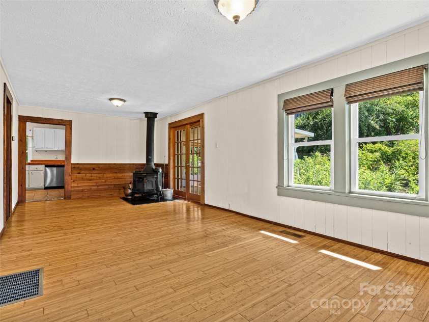 83 5th Avenue, Asheville, NC 28806.  MLS# CAR4275954, YatesRealty ID 25294. Living room in main home looking into the kitchen