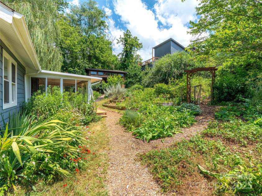 83 5th Avenue, Asheville, NC 28806.  MLS# CAR4275954, YatesRealty ID 25294. Pathways throughout the property lead you through the gardens and to both homes