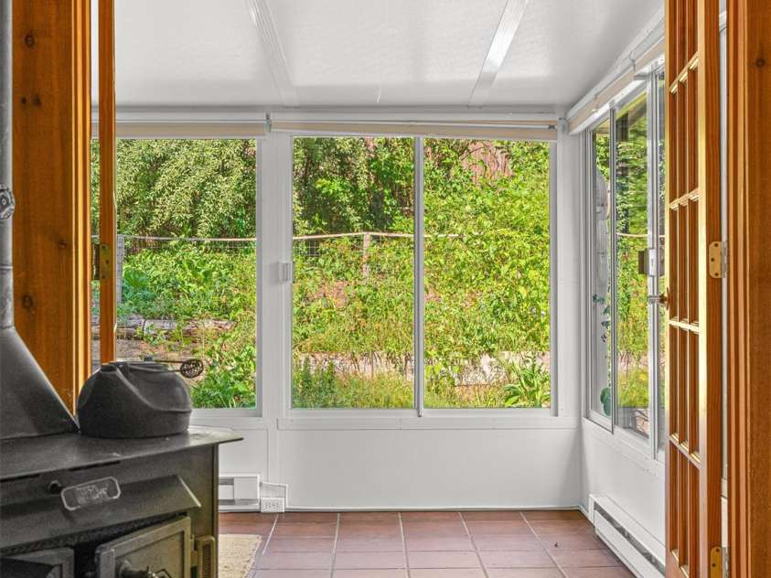 83 5th Avenue, Asheville, NC 28806.  MLS# CAR4275954, YatesRealty ID 25294. Step into the sunroom from the living room.