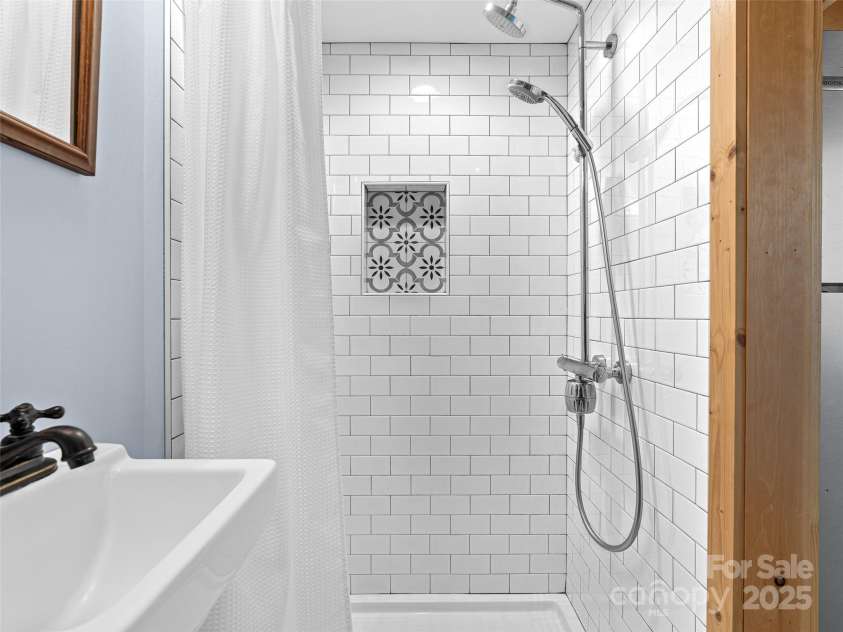 83 5th Avenue, Asheville, NC 28806.  MLS# CAR4275954, YatesRealty ID 25294. Tiny cottage tile shower, bathroom has heated floor