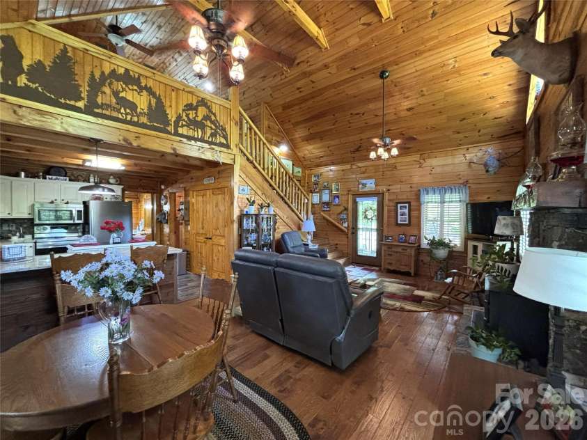 361 Black Camp Gap Road, Maggie Valley, NC 28751.  MLS# CAR4383045, YatesRealty ID 25299. Dining area, living room with open concept kitchen.
