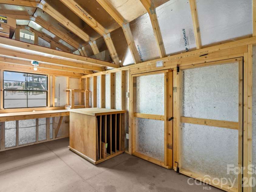40 New Elijah Way, Fletcher, NC 28732.  MLS# CAR4384158, YatesRealty ID 25305. Insulated shed with workbench 