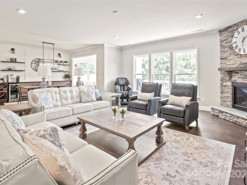 6320 Tilley Way, Matthews, NC 28105.  MLS# CAR4274022, YatesRealty ID 25314. Cozy up by the beautiful stone fireplace in this spacious, open living area—perfect for relaxing or entertaining.