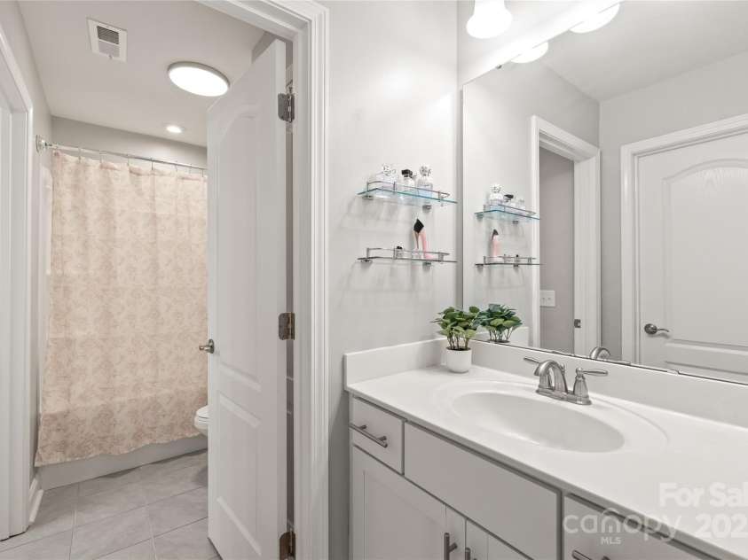 6320 Tilley Way, Matthews, NC 28105.  MLS# CAR4274022, YatesRealty ID 25314. Enjoy added privacy in Bedroom 3 with a personal sink and vanity, perfect for busy mornings or guests.