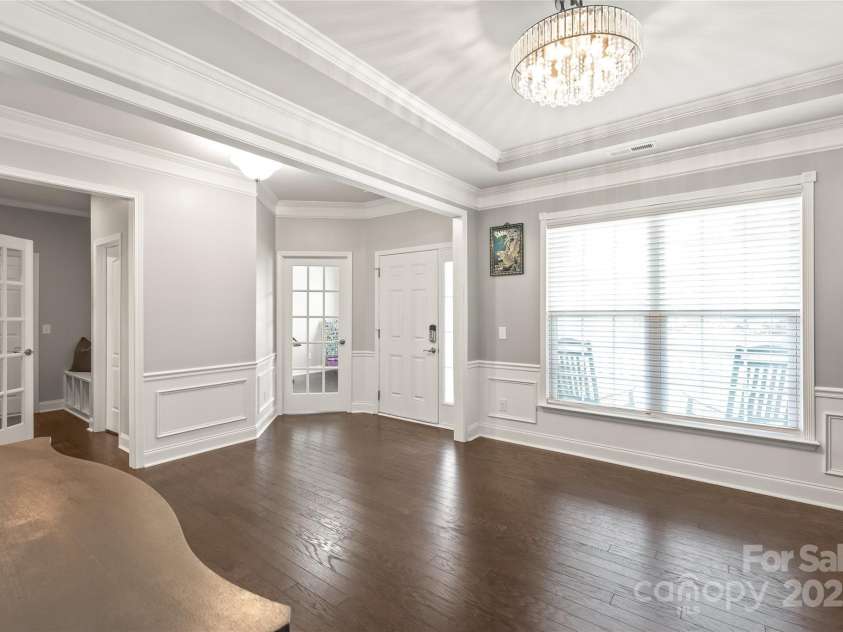 6320 Tilley Way, Matthews, NC 28105.  MLS# CAR4274022, YatesRealty ID 25314. Formal meets inviting—tray ceilings, crisp crown molding, and designer lighting create a warm and elevated dining experience.