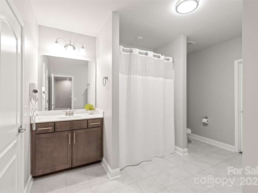 6320 Tilley Way, Matthews, NC 28105.  MLS# CAR4274022, YatesRealty ID 25314. Ideal for multigenerational living or guests, the basement’s second ensuite includes a full bath and roomy walk-in closet.
