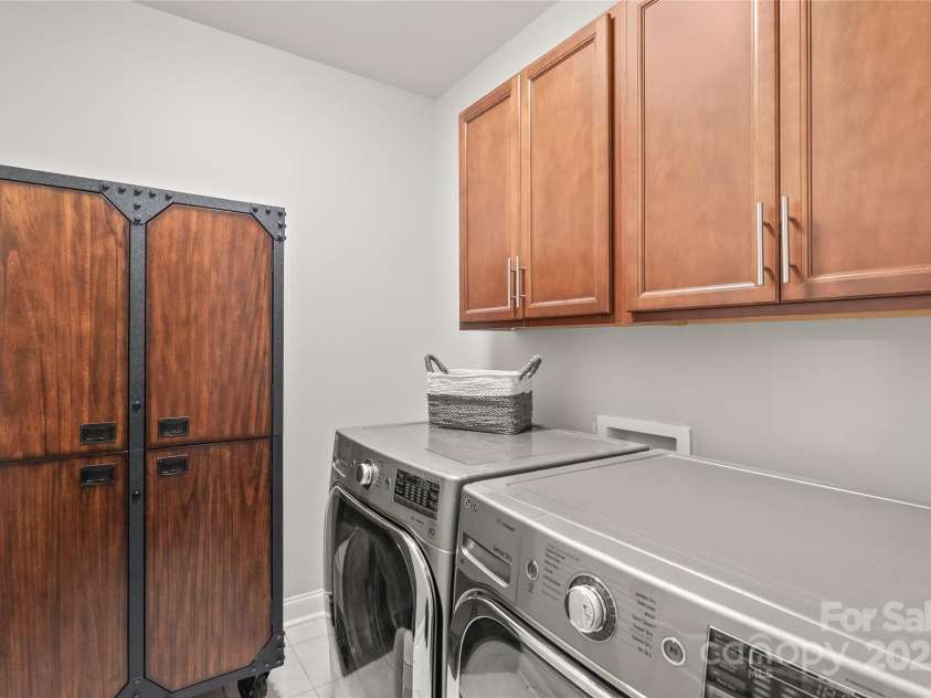 6320 Tilley Way, Matthews, NC 28105.  MLS# CAR4274022, YatesRealty ID 25314. Stay efficient and clutter-free with a roomy laundry area complete with upper cabinetry for added storage.