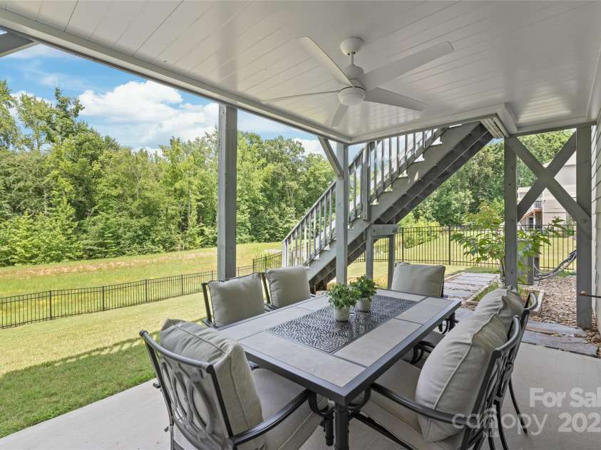 6320 Tilley Way, Matthews, NC 28105.  MLS# CAR4274022, YatesRealty ID 25314. This upgraded covered porch offers a spacious, sheltered retreat for outdoor living and entertaining, rain or shine.