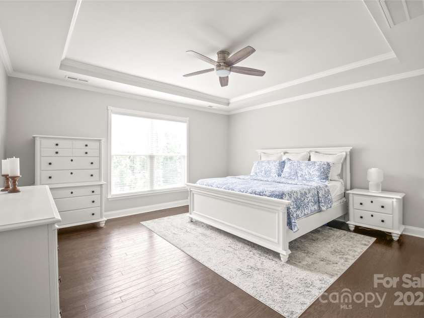 6320 Tilley Way, Matthews, NC 28105.  MLS# CAR4274022, YatesRealty ID 25314. Tray ceilings elevate the space, natural light fills the room, and a ceiling fan ensures comfort no matter the season.
