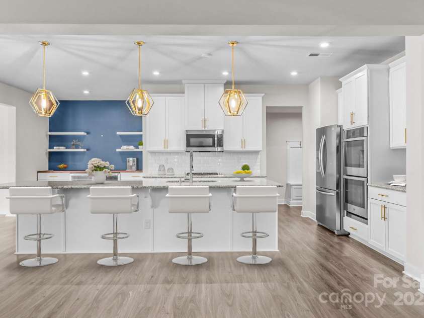 12710 ES Draper Drive, Huntersville, NC 28078.  MLS# CAR4245937, YatesRealty ID 25327. Virtual staging of the kitchen to show comfortably space for 4 barstools