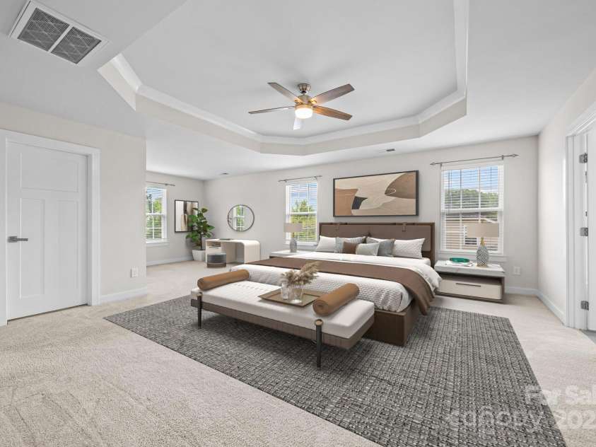 12710 ES Draper Drive, Huntersville, NC 28078.  MLS# CAR4245937, YatesRealty ID 25327. Virtual staging of the primary bedroom with dedicated seating area