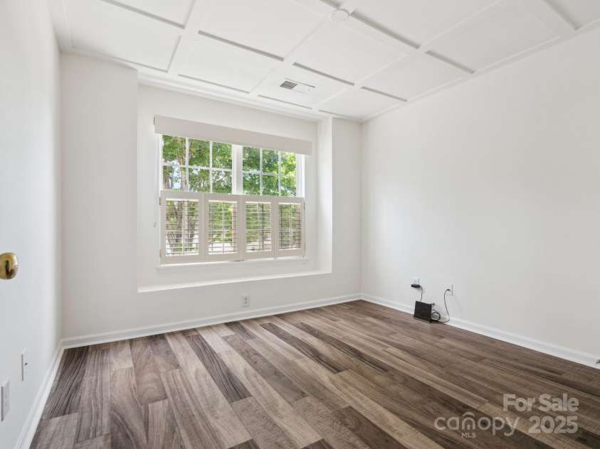 146 Rapids Road, Fort Mill, SC 29715.  MLS# CAR4269060, YatesRealty ID 25328. Guest Bedroom has laminatel flooring and a coffered ceiling with a great view of the neighborhood pool.