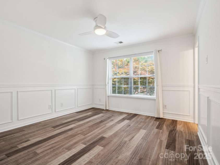 146 Rapids Road, Fort Mill, SC 29715.  MLS# CAR4269060, YatesRealty ID 25328. Primary Bedroom is on the second floor. It has luxury Vinyl flooring, new paint, wainscoting and crown molding with a nice view of the maple tree in the backyard.