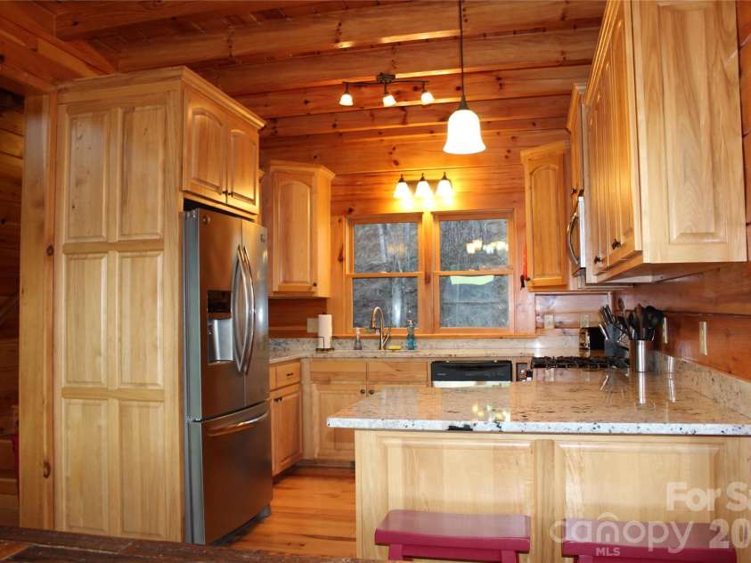 109 Overlook Point Lane, Lake Lure, NC 28746.  MLS# CAR4336925, YatesRealty ID 2533. Kitchen with breakfast bar, granite countertops and stainless steel, appliances