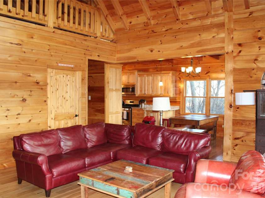 109 Overlook Point Lane, Lake Lure, NC 28746.  MLS# CAR4336925, YatesRealty ID 2533. The Living Room is open to the dining room and kitchen. All 