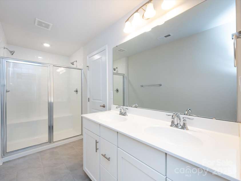 403 Park Meadows Drive, Matthews, NC 28104.  MLS# CAR4263302, YatesRealty ID 25331. Large shower in Primary Bathroom