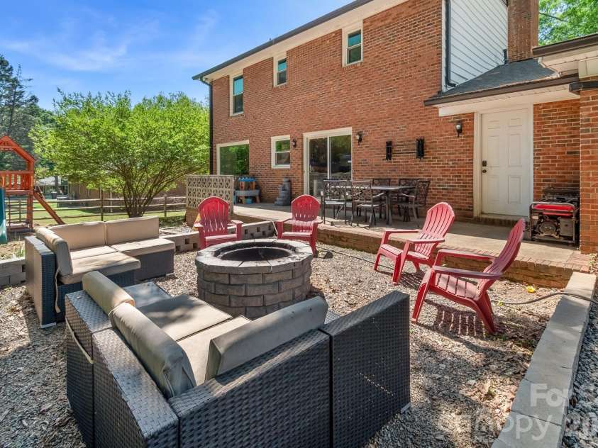 6070 Ferncliff Drive, Concord, NC 28027.  MLS# CAR4371850, YatesRealty ID 25333. Dug in fire pit area.