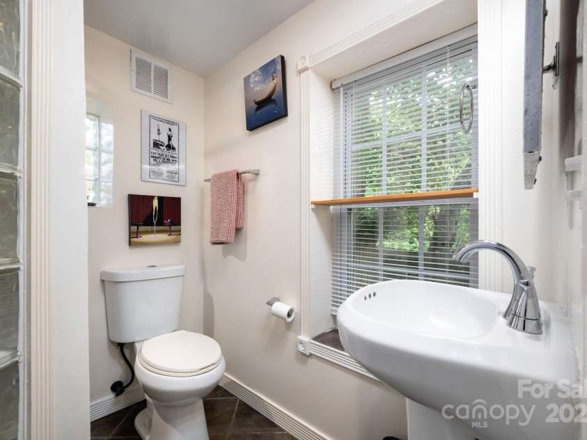5 Arbutus Road, Asheville, NC 28805.  MLS# CAR4270691, YatesRealty ID 25344. Bathroom with Glass Block Accent