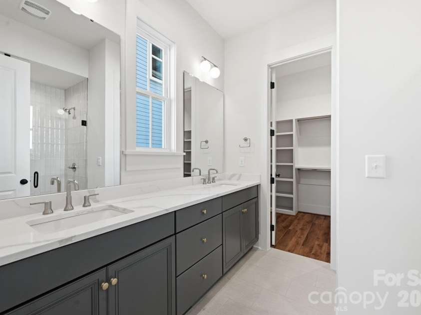 7237 Westrow Avenue, Charlotte, NC 28278.  MLS# CAR4311743, YatesRealty ID 2535. Beautiful primary bath offers dual vanity, abundant storage and large zero entry tile shower.
