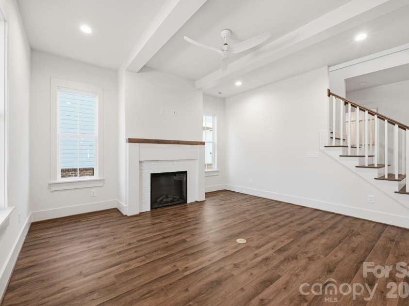 7237 Westrow Avenue, Charlotte, NC 28278.  MLS# CAR4311743, YatesRealty ID 2535.  Family room is filled with natural light and showcases ceiling beams. A cozy fireplace enhances this inviting space.