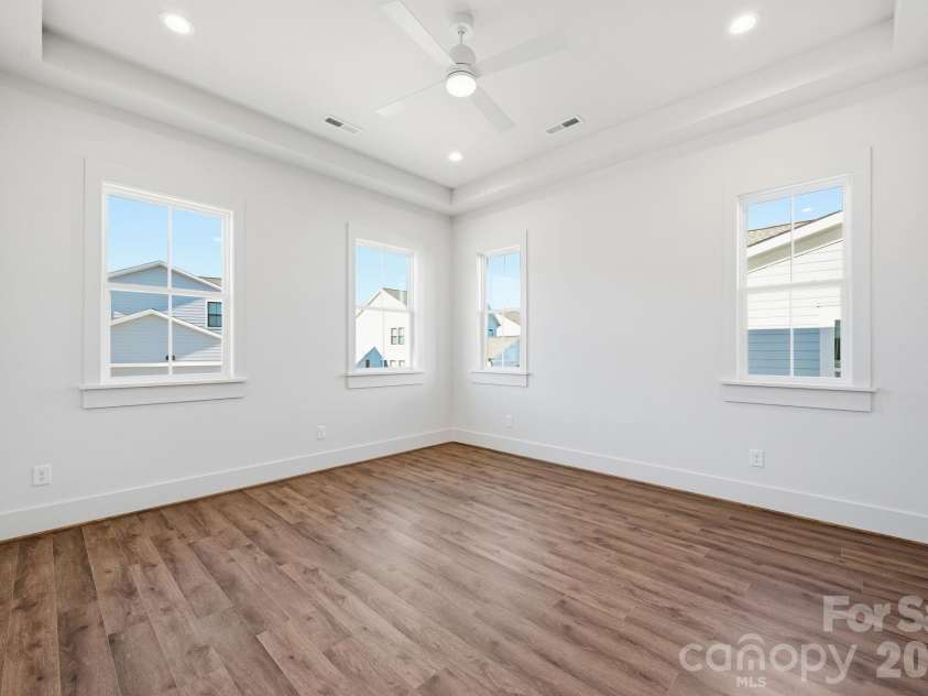 7237 Westrow Avenue, Charlotte, NC 28278.  MLS# CAR4311743, YatesRealty ID 2535. First floor primary bedroom is enhanced with tray ceiling, recessed lighting and an abundance of windows. 