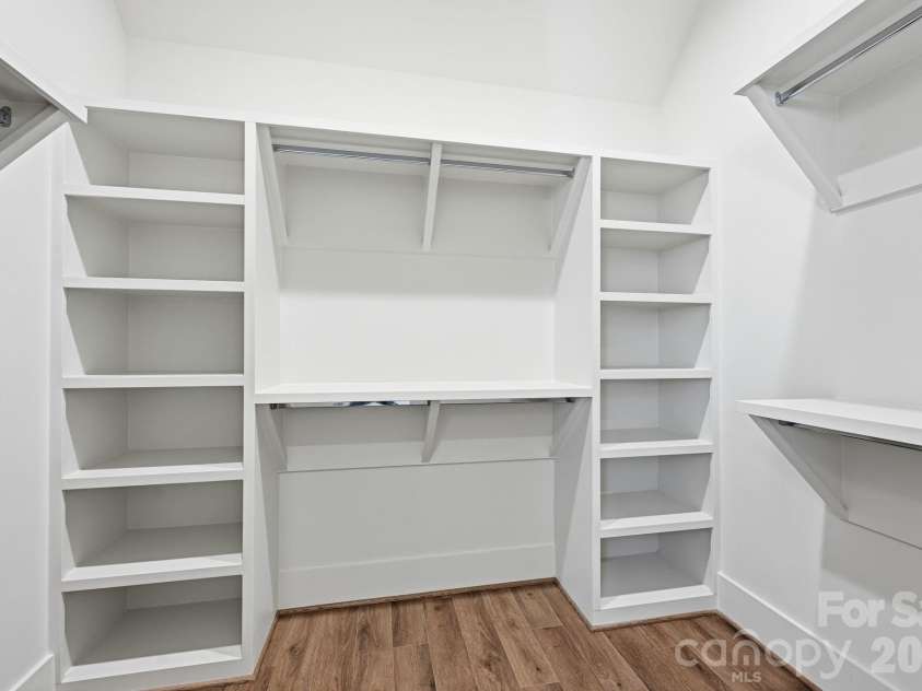 7237 Westrow Avenue, Charlotte, NC 28278.  MLS# CAR4311743, YatesRealty ID 2535. Large primary bedroom closet offers solid shelving and several options for apparel storage.