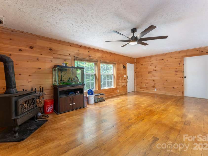 116 Hidden Meadow Drive, Candler, NC 28715.  MLS# CAR4258424, YatesRealty ID 25356. Family Room (Wood Stove)